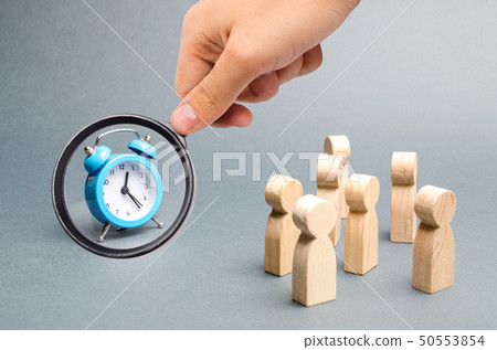 Magnifying glass is looking at the blue clock. Magnifying glass is looking at the blue clock. 50553854