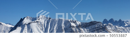 Panoramic view of snowy mountains at sunny winter 50553887
