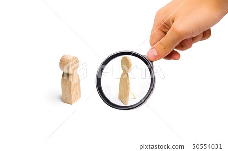 Magnifying glass is looking at the a fake person. Magnifying glass is looking at the a fake person. 50554031