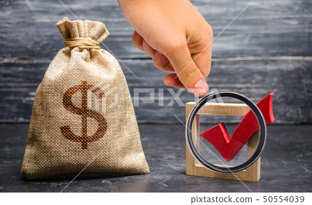 Magnifying glass is looking at a red check mark Magnifying glass is looking at a red check mark 50554039