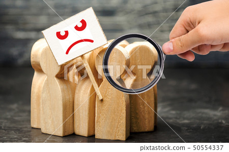 Magnifying glass is looking at an angry mob  50554337