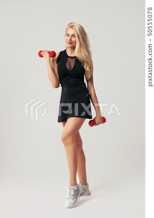 beautiful woman holding red dumbell beautiful woman holding red dumbell 50555078