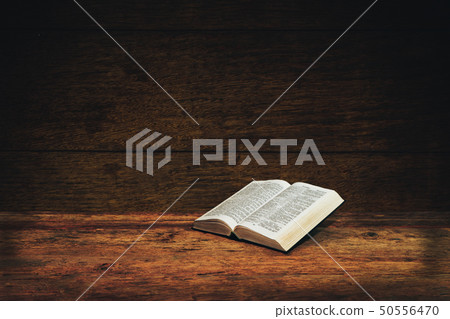 Bible on a old wooden table background. Bible on a old wooden table background. 50556470
