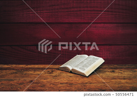 Bible on a old wooden table background. Bible on a old wooden table background. 50556471