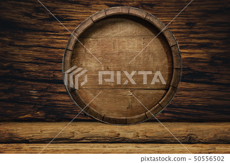 Wooden barrel and worn old table of wood. 50556502