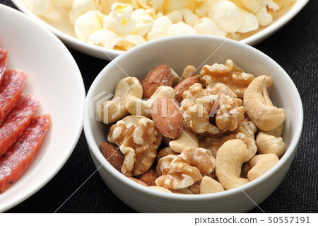 A snack image with a focus on mixed nuts. 50557191