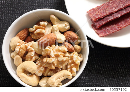 A snack image with a focus on mixed nuts. A snack image with a focus on mixed nuts. 50557192