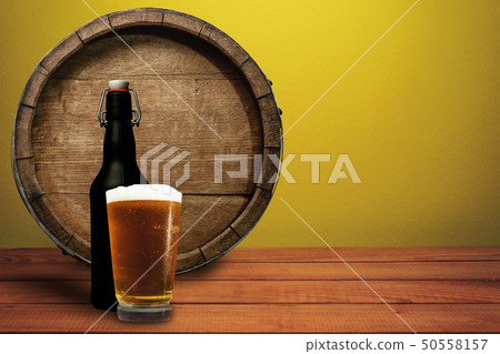 Wooden barrel, glass of beer and black bottle on a Wooden barrel, glass of beer and black bottle on a 50558157