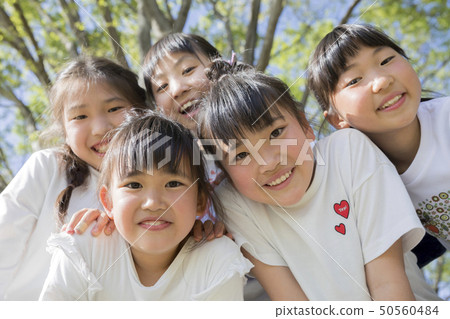 Children looking into the camera at the park 50560484