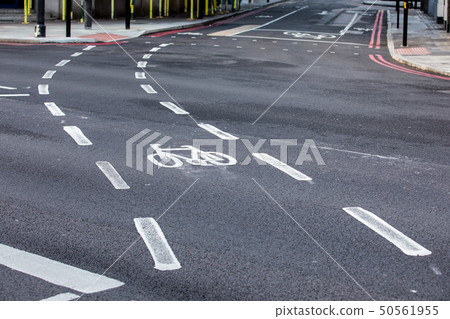 Bicycle road sign painted on the asphalt road Bicycle road sign painted on the asphalt road 50561955