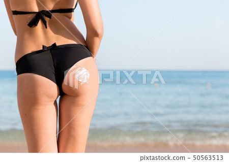 Tanned woman with sunscreen on body Tanned woman with sunscreen on body 50563513