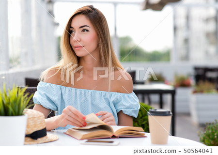 Beautiful woman in a blue dress, girl in summer. Looks aside, dreams, dreams, joyful thoughts. Long Beautiful woman in a blue dress, girl in summer. Looks aside, dreams, dreams, joyful thoughts. Long 50564041