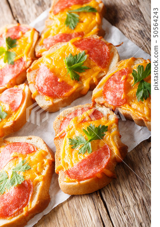 Hot baked toast with sausage and melted cheese Hot baked toast with sausage and melted cheese 50564243