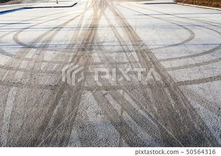 Tyre track on parking lot at winter Tyre track on parking lot at winter 50564316