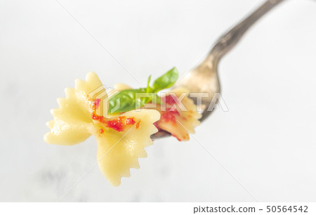 Piece of butterfly pasta on a fork 50564542