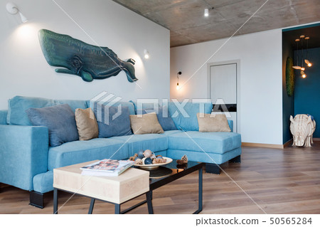 Minimalist modern living room with sofa in loft style flat. Modern loft studio with living room Minimalist modern living room with sofa in loft style flat. Modern loft studio with living room 50565284