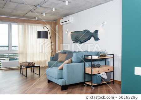 Minimalist modern living room with sofa in loft style flat. Modern loft with a kitchen and living 50565286