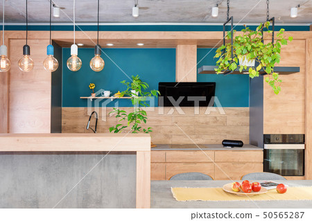 Modern furniture in luxury kitchen. Minimalist scandinavian interior in loft apartment with wooden Modern furniture in luxury kitchen. Minimalist scandinavian interior in loft apartment with wooden 50565287