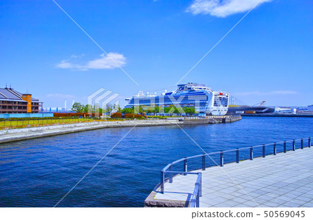 A large passenger boat anchored in the Yokohama Minato Mirai area and the large pier 50569045
