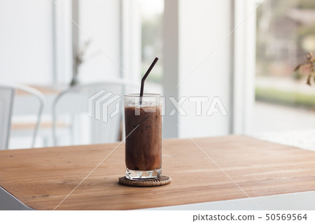 Ice coffee on wooden table Ice coffee on wooden table 50569564