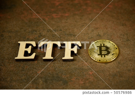 Bitcoin coin with ETF text on stone background Bitcoin coin with ETF text on stone background 50576986