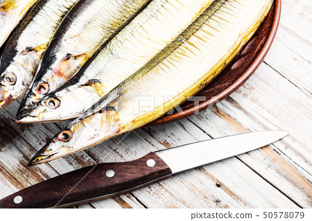 Hot smoked fish on plate 50578079