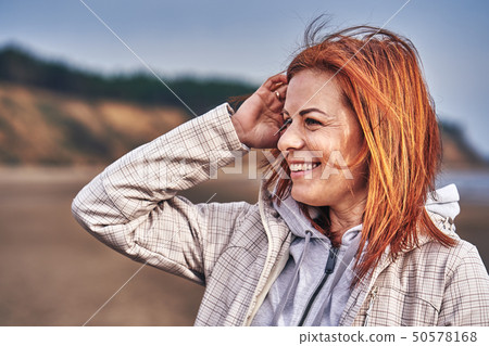 Portrait of a laughing middle-aged woman with red Portrait of a laughing middle-aged woman with red 50578168