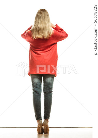 fashion woman in vivid color red coat rear view 50579228