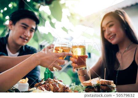 Group of asian people cheering beer at restaurant Group of asian people cheering beer at restaurant 50579632