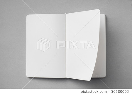 white notebook with turn page on grey background white notebook with turn page on grey background 50580003