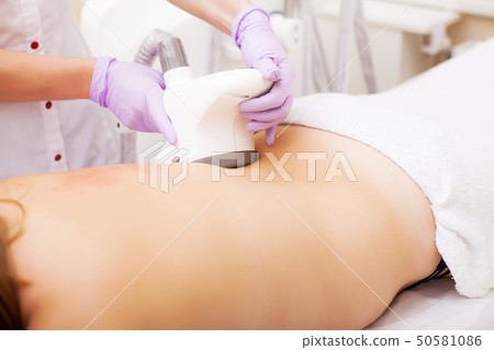 Body Care. Woman is in the process at the clinic lipomassage 50581086