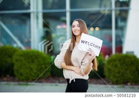 Women business with the poster with welcome message Women business with the poster with welcome message 50581210