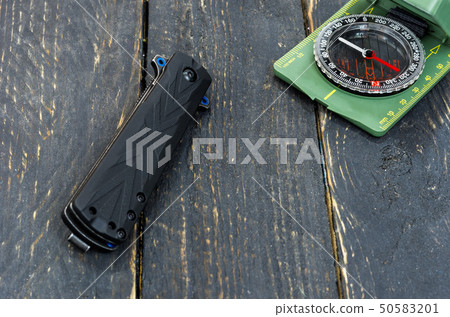 Tourist image. Composition of a knife and a compas 50583201