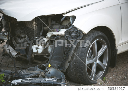 Broken and crashed modern car after an accident on street 50584917