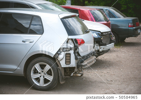 Broken and crashed modern cars after an accident on street Broken and crashed modern cars after an accident on street 50584965