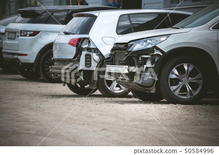 Broken and crashed modern car after an accident on street Broken and crashed modern car after an accident on street 50584996