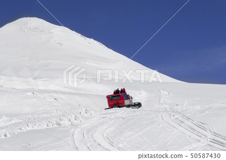 A group of tourists climb a snowcat on a Mount Elbrus A group of tourists climb a snowcat on a Mount Elbrus 50587430