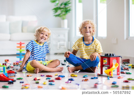 Kids play with toy cars. Children playing car toys Kids play with toy cars. Children playing car toys 50587892