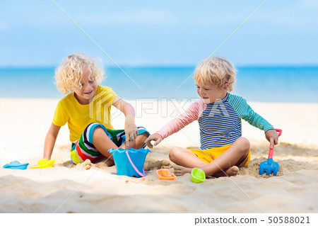 Kids playing on beach. Children play at sea. Kids playing on beach. Children play at sea. 50588021