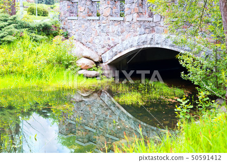 Old stone bridge with reflection in water lake in Feofaniya park, Kyiv, Ukraine Old stone bridge with reflection in water lake in Feofaniya park, Kyiv, Ukraine 50591412