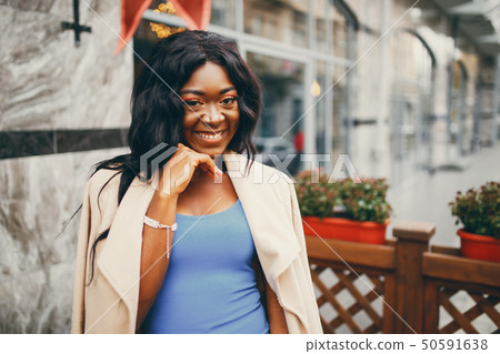 Black woman standing in a autumn city 50591638