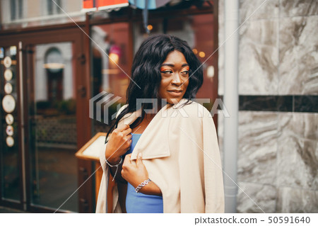 Black woman standing in a autumn city 50591640