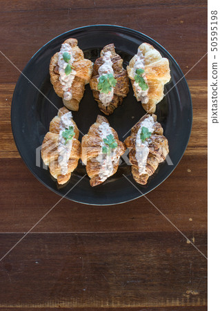 Croissant with Tuna Salad  Sandwich on wood table 50595198