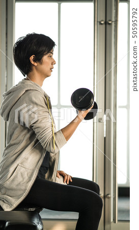 Smiling Asian short hair woman fitness dumbbell Smiling Asian short hair woman fitness dumbbell 50595792