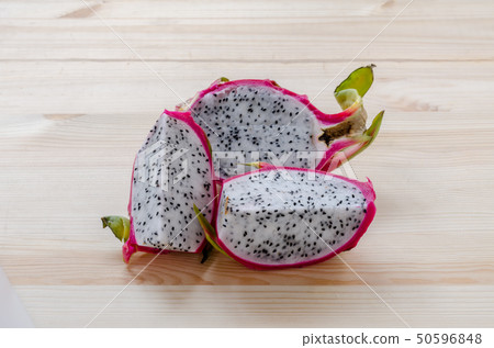Fresh dragon fruits on wooden background. 50596848