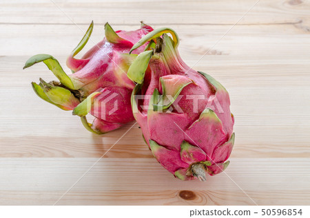 Fresh dragon fruits on wooden background. 50596854