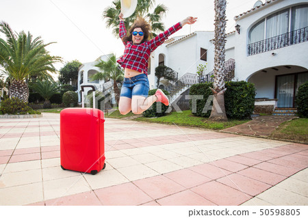 Travel, tourism, emotions and people concept - happy young woman having fun fooling around in a hat Travel, tourism, emotions and people concept - happy young woman having fun fooling around in a hat 50598805
