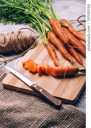 Fresh carrots sliced with a knife on a cutting board Fresh carrots sliced with a knife on a cutting board 50599268