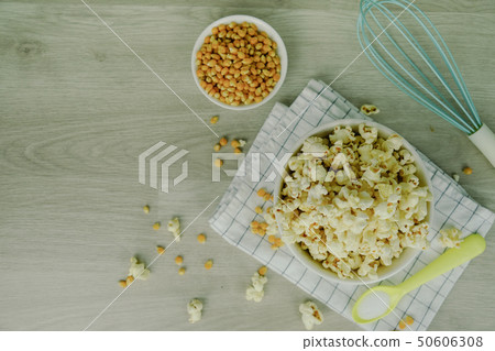 Popcorn in white bowl with pastel spoon, salt, Popcorn in white bowl with pastel spoon, salt, 50606308
