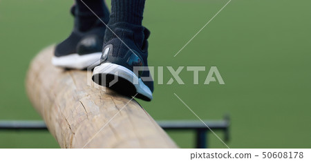 The feet of a athlete as she's walking on a wooden The feet of a athlete as she's walking on a wooden 50608178